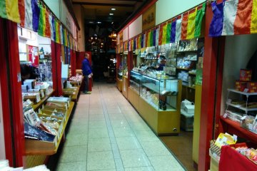 <p>The alley leading to the temple is lined with shops</p>