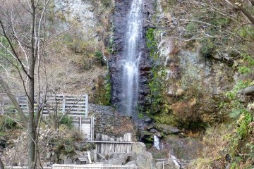 <p>A waterfall plunges down to the edge of the outdoor baths</p>