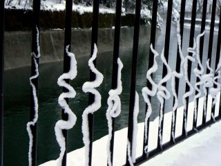 Curlicues formed by snow sliding down the metal rails