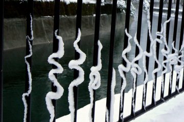 <p>Curlicues formed by snow sliding down the metal rails</p>