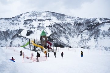 <p>A playground right in the middle of snowy mountains</p>