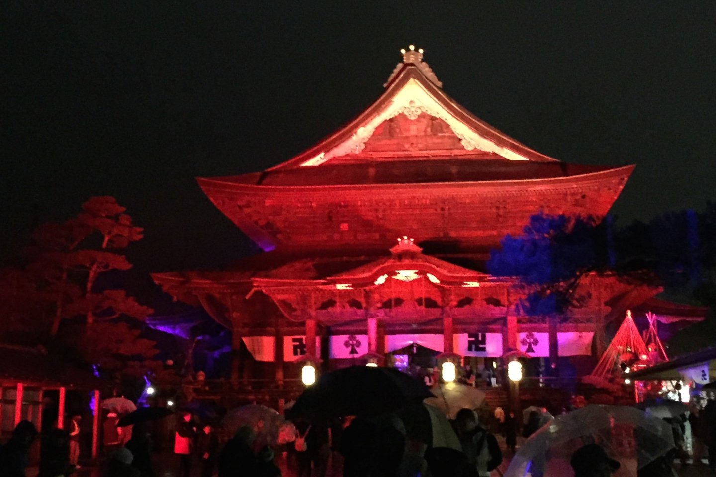 The main hall of Zenkoji, lit up in firey red