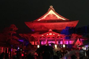 The main hall of Zenkoji, lit up in firey red
