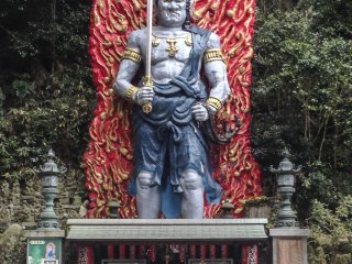 A massive and colorful statue of the great Buddhist deity, Fudō Myō-ō.