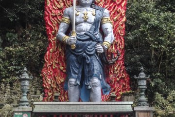 A massive and colorful statue of the great Buddhist deity, Fudō Myō-ō.