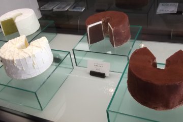 <p>Cakes on display, possibly plastic models</p>