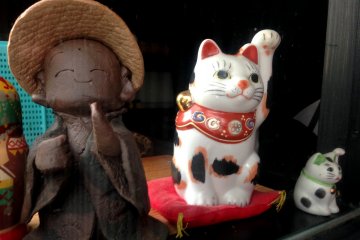 The maneki-neko or beckoning cat is makes a popular appearance.