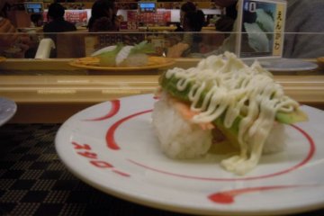 Some quirky sushi flavors, such as this avocado-shrimp-mayonnaise combo, can be found at kaiten-zushi
