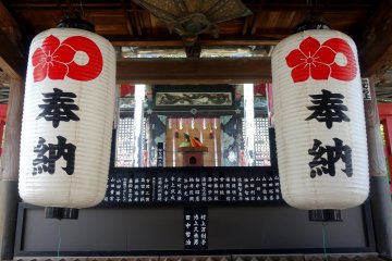 <p>Two lanterns hang over the temple&#39;s offering box</p>