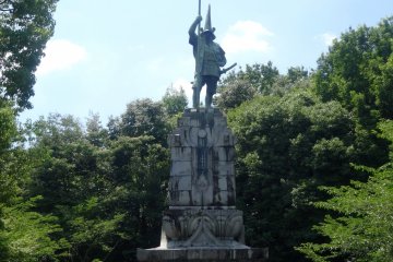 <p>A statue of Kumamoto ruler Kato Kiyomasa stands on the hill above the temple</p>