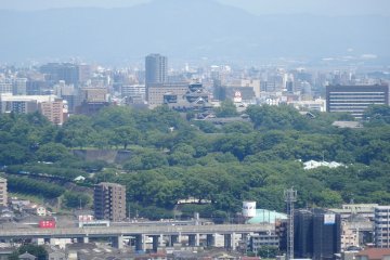 <p>A glimpse of Kumamoto Castle from Honmyo-ji&#39;s viewpoint</p>
