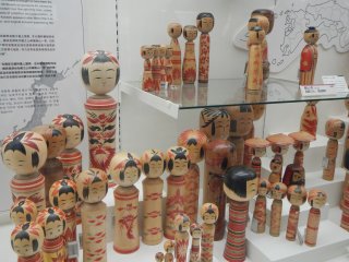 Kokeshi folk dolls originally from Northern Japan are carved from wood.&nbsp;This makes a good souvenir item