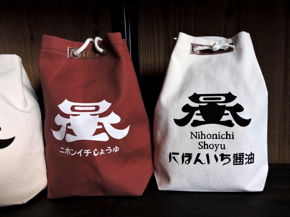 The gift bags are made of cloth and decorated with the company logo