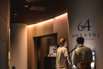 <p>A couple looking at the menu for the Skytree restaurant</p>