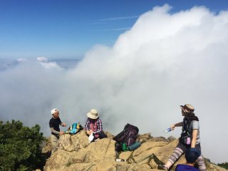 Hikers take a rest at the mountain top of Mt. Shibutsu.