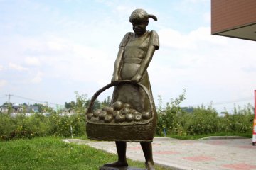 <p>Statue of a girl with a bucket of apples</p>
