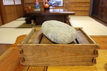 <p>The stone weight and box used to press and preserve the sushi</p>