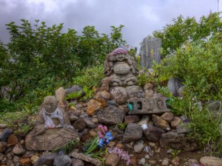 Another pebble and stone shrine with statues