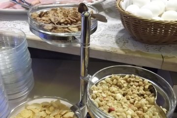 <p>Cereal, ham and eggs on the breakfast buffet</p>
