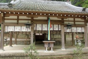 The donation box, bell pull and gate to the main shrine in the background
