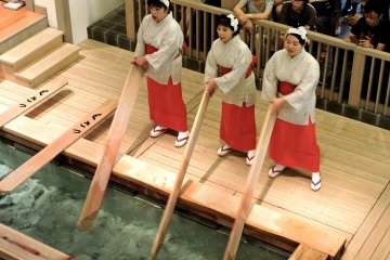 <p>The women turn the paddle one way then the other, swishing the water</p>