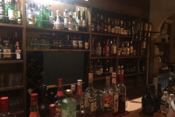 <p>Only a portion of the drinks available behind the bar.</p>