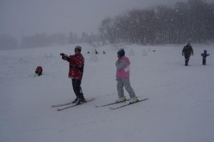 Skiiers being pelted by snowflakes