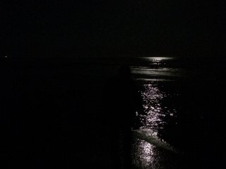 The moon&#39;s reflection over the ocean.