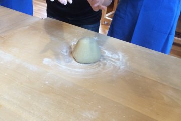<p>The instructor showing us how to knead the dough properly.</p>