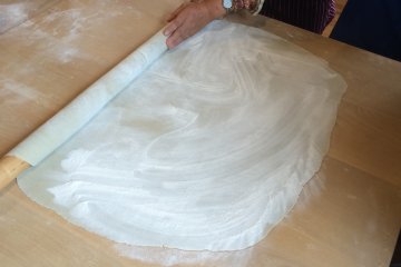 <p>We rolled the dough into a square.</p>