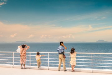 A family enjoys the fresh clean air on their voyage