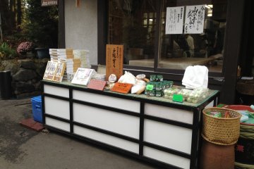 <p>Soba making ingredients are sold in front of the restaurant. The window on its back shows the room where the cooks make the soba dough.</p>