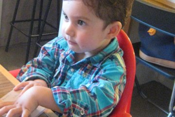 My son seated in the high chair.
