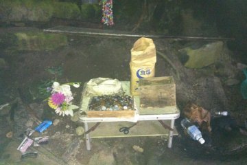 Often in Japan, you find covered places in nature have some kind of shrine in them, this one has a bag of table salt on it amongst other things