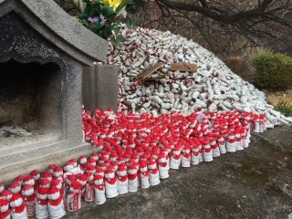 You can write a prayer on these red-capped mini-statues.