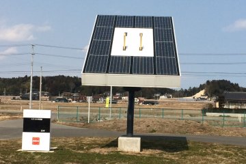 A statue of a solar panel that looks like an outlet is a reminder that there are other available sources of energy.
