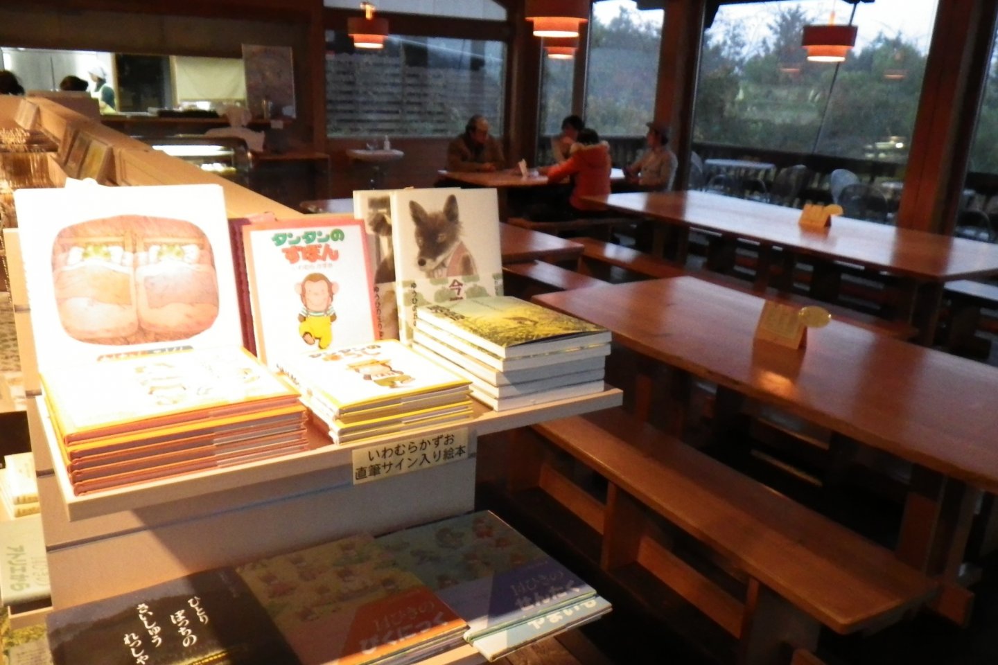 Book shelf of gift shop with cafe area in the background