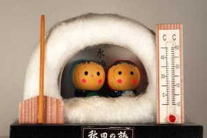 traditional dolls in a snow hut