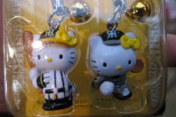 Hello Kitty dressed up in Hanshin Tigers baseball uniform! I love how they look so professional in their poses.