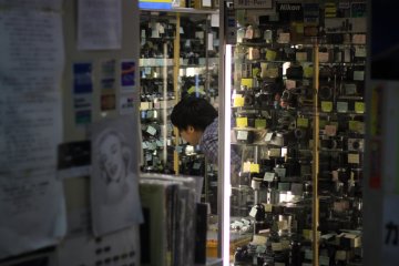Customer looking through old pieces of cameras