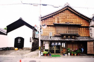 A modern-looking izakaya sits next to a traditional sweets shop