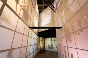 The installation of shadows reflecting on paper reaches up to the 3rd floor