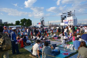 An open lawn area where people can sit and enjoy live performances on stage or grab an early spot before the fireworks show