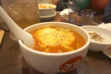The tomato ramen topped with cheese is delicious