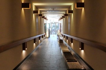 Hall, with foot massage walking path, leading to the onsen