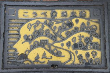 Historical district Kitano Ijinkan to Kobe Harborland depicted on this manhole cover