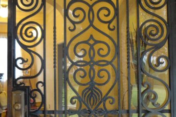 <p>A beautiful iron gate greets visitors at the entrance</p>