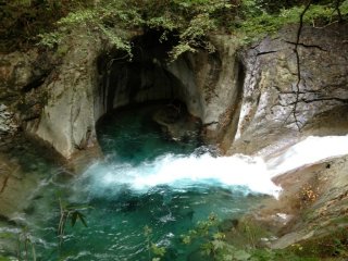 You'll find beautiful aquamarine water, like the water at the base of these rocks in this small river grotto. The cool shade and sparkling water will cool you in the summer's heat.