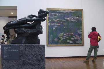 A visitor studies a famous piece by Claude Monet