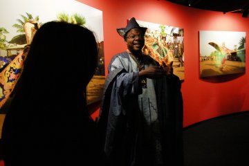Yoruba artist Romuald Hazoumè giving an explanation of his exhibition